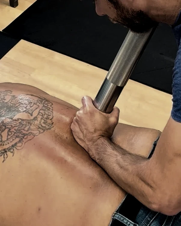 Body tempering with a weighted steel cylinder into the lower back at Achieve Chiropractic in Newport News, VA